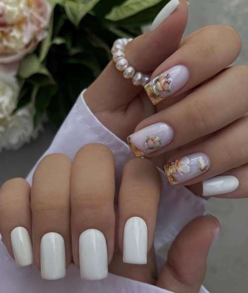 Manucure blanche avec différents motifs pour le printemps